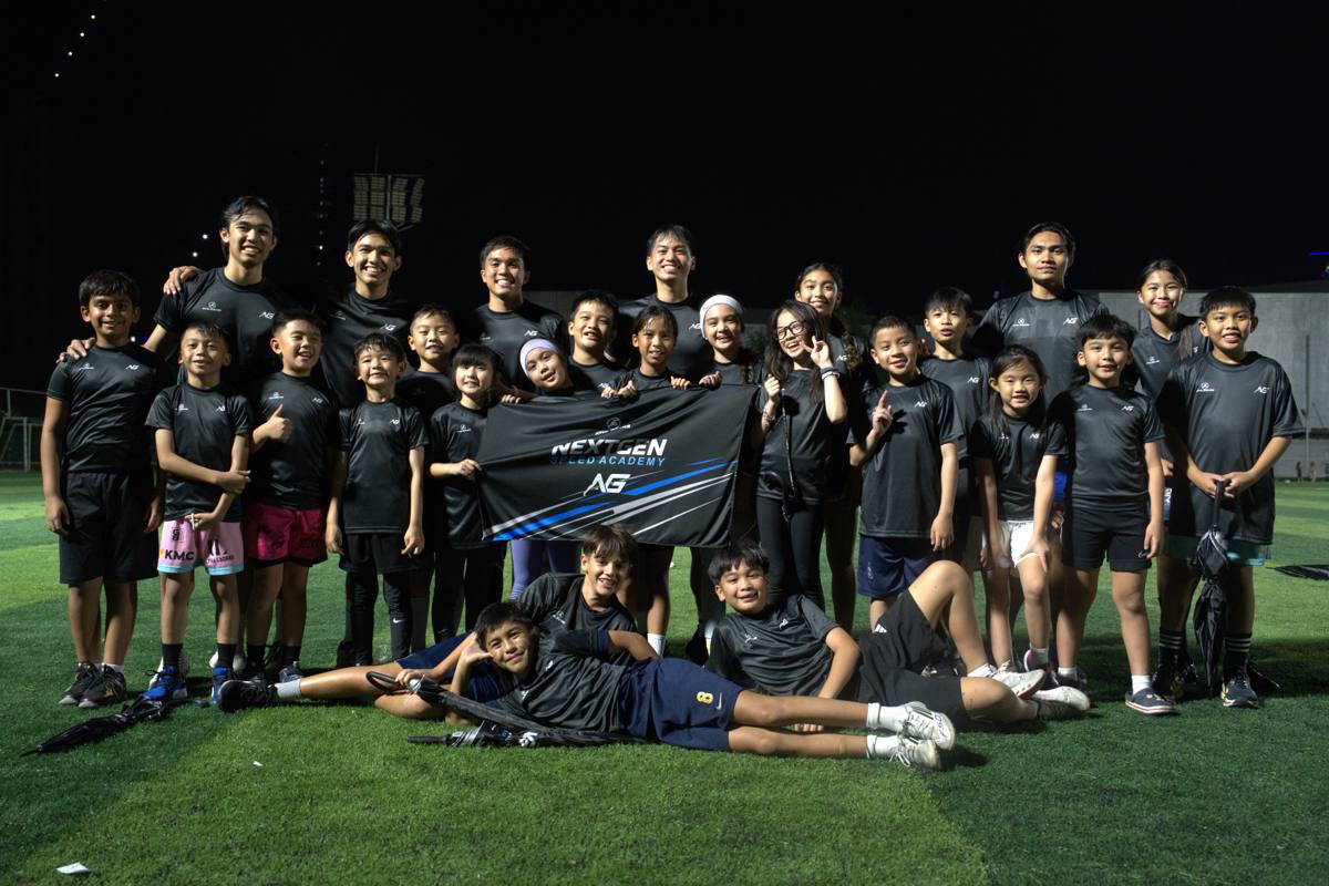 NextGen Speed Academy athletes and coaches together on the field with the academy banner