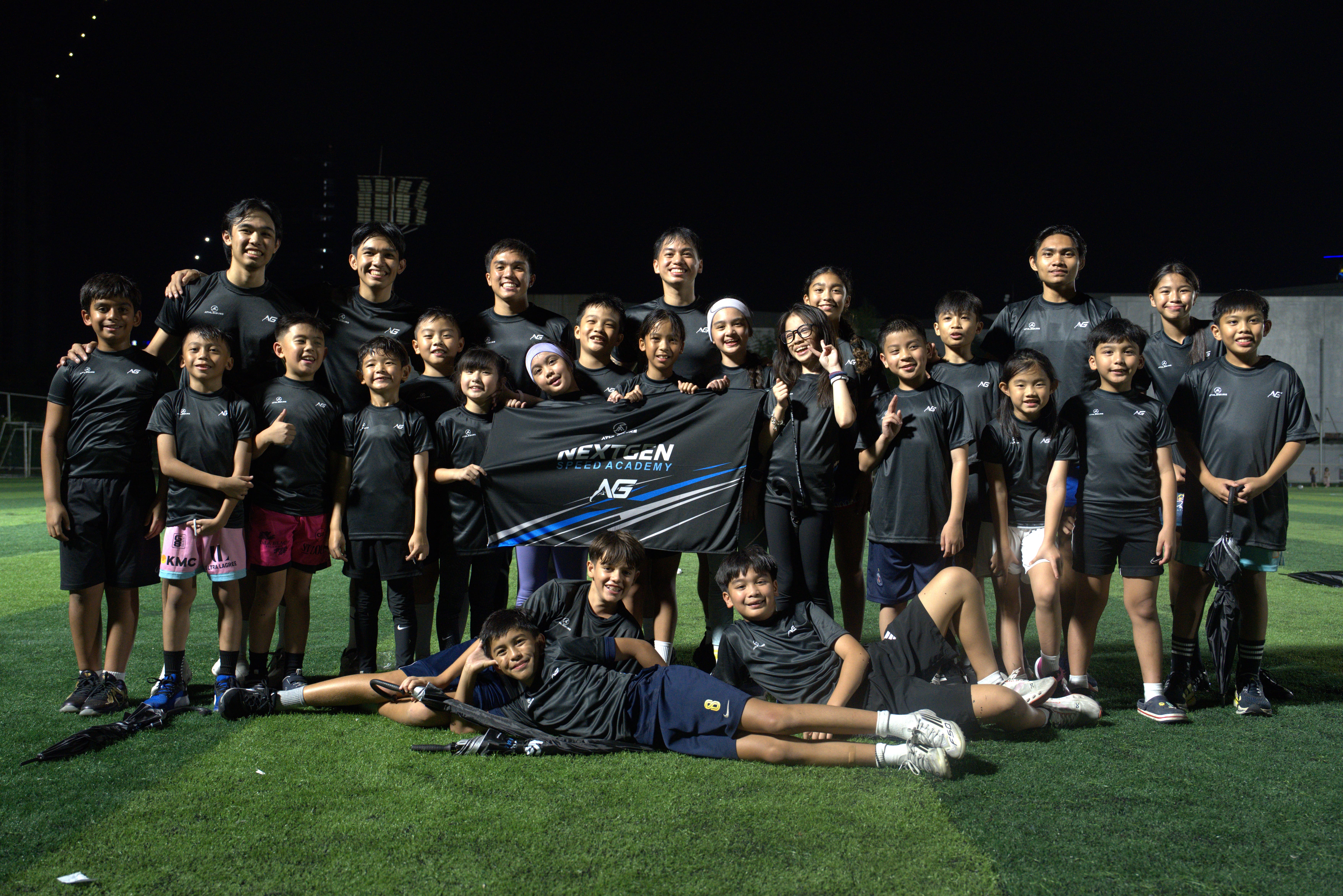 NextGen Speed Academy athletes and coaches together on the field with the academy banner